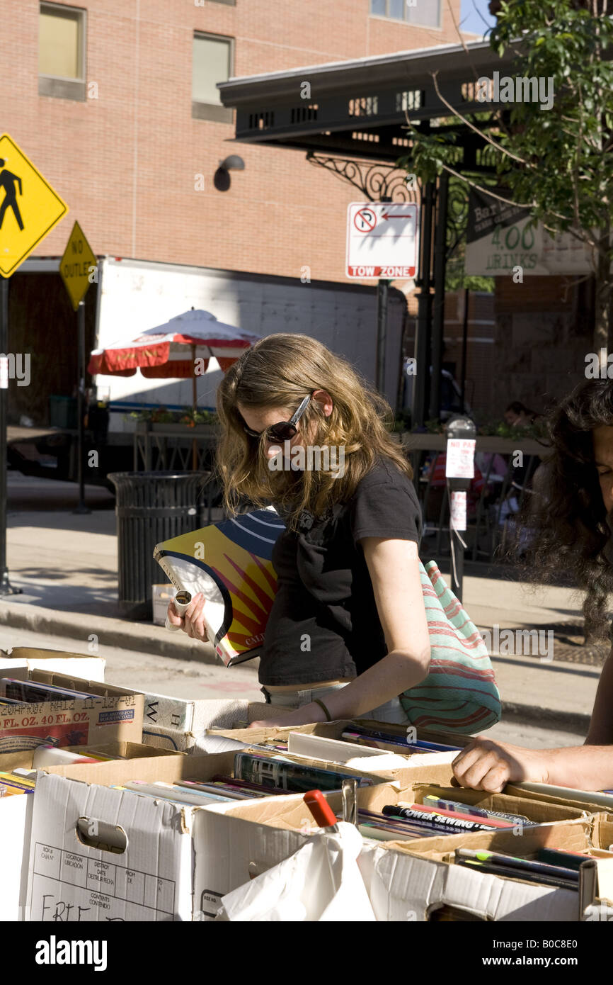 woman looking at a bookseller stall at Printers Row book fair and sale