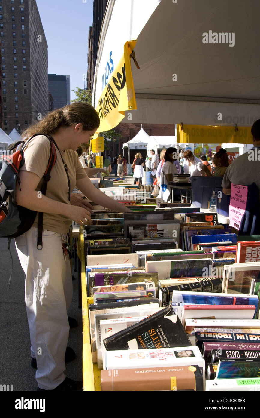 woman looking at a bookseller stall at Printers Row book fair and sale