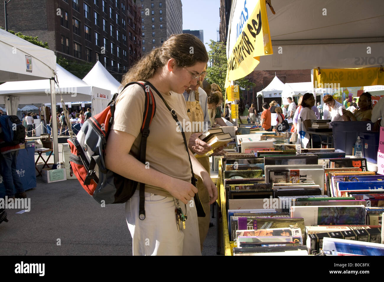 woman looking at a bookseller stall at Printers Row book fair and sale