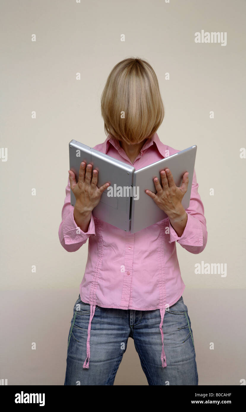 Woman holding a laptop like a book Stock Photo