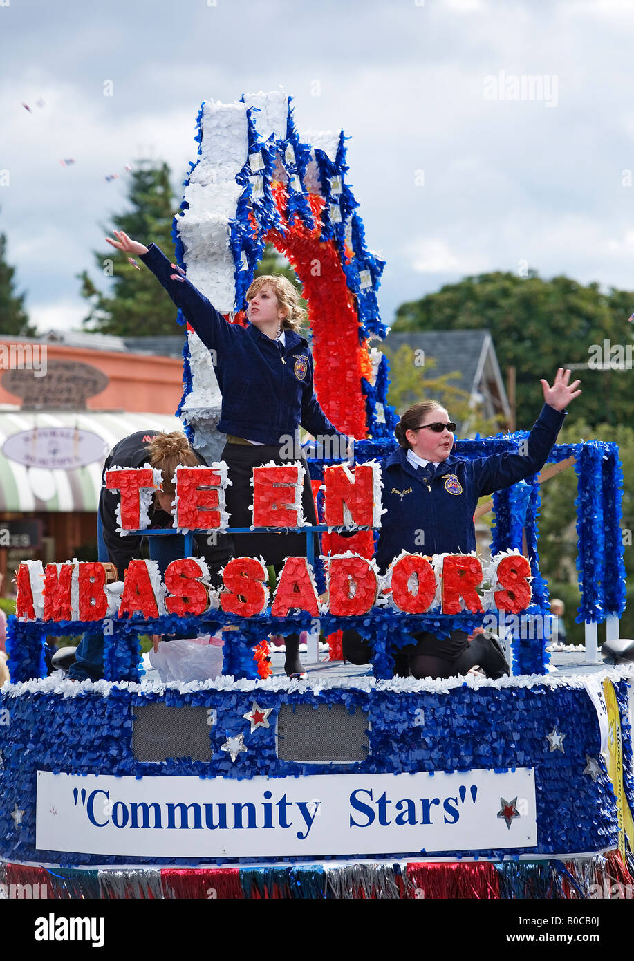Image of Two teenage girls dressed in Future Farmers of America uniforms throwing candies in a parade Stock Photo