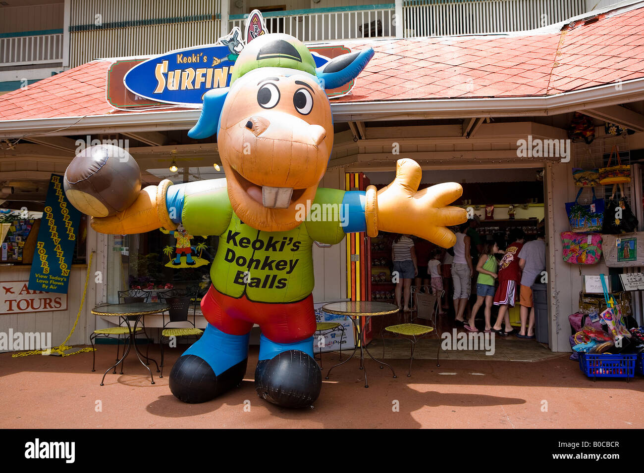 Image of the exterior of Keoki s Donkey Balls storefront including the huge inflatable donkey and a few shoppers inside store Stock Photo