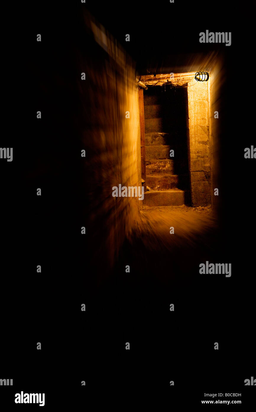 Image of a long dark tunnel made of brick and concrete with light at the end and staircase leading up and away Stock Photo - Alamy