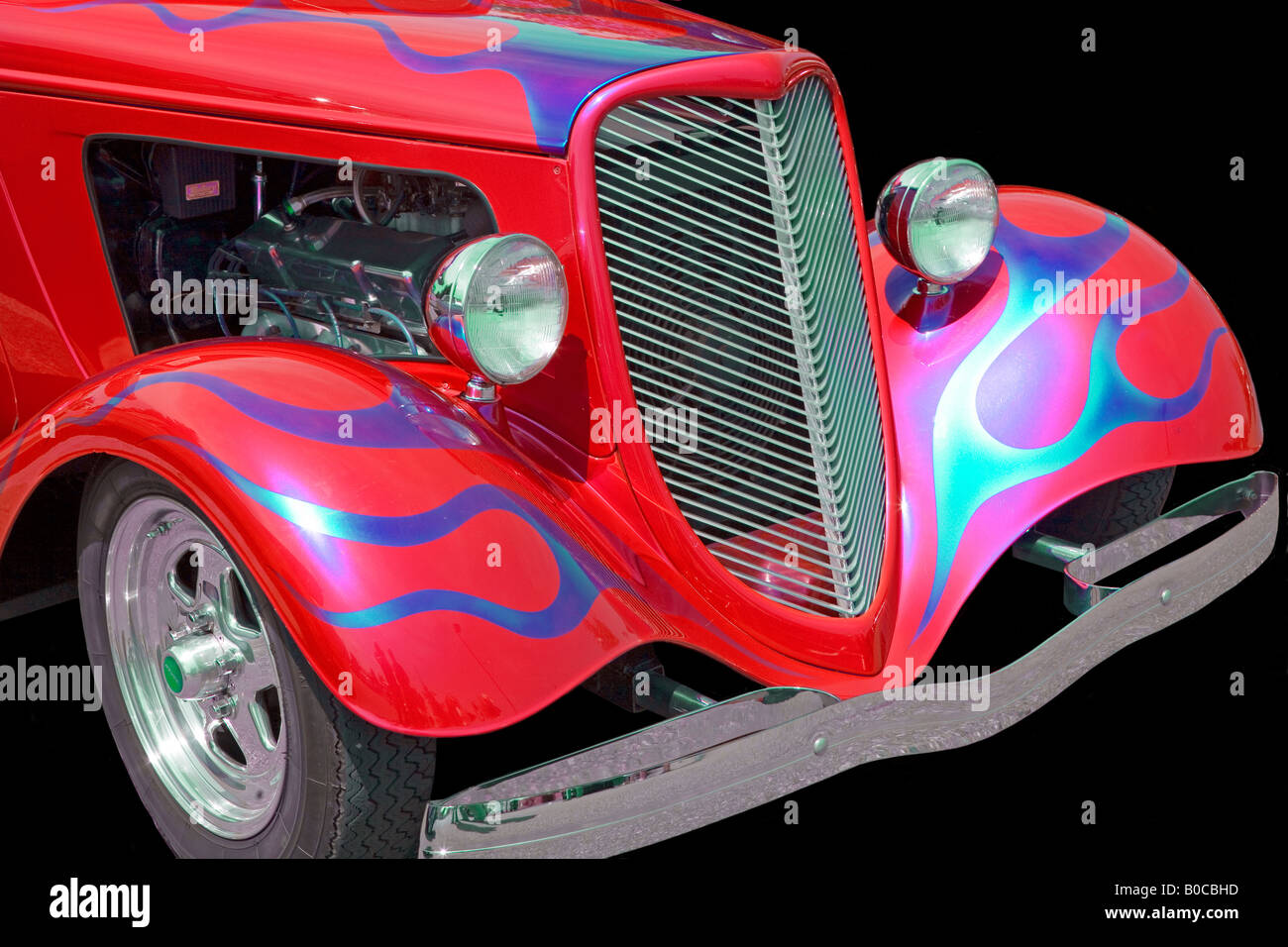 Illustration of a red 1934  Ford Coupe front and side view cut out and on a black background Silhouette Stock Photo