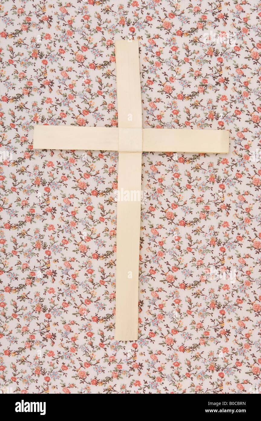 Cross on floral wallpaper Stock Photo