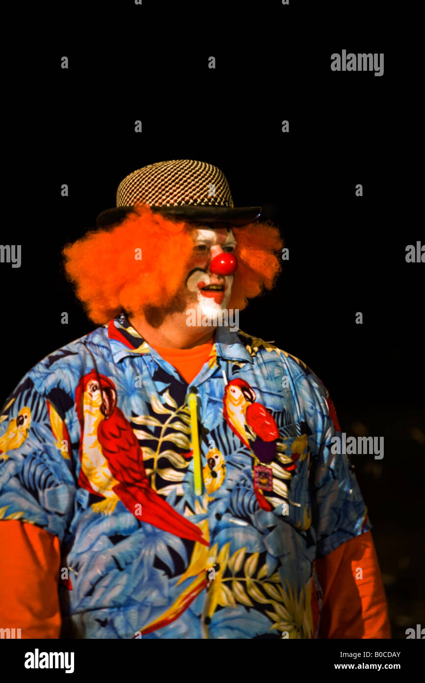 Clown wearing bright fun colorful clothes in the Fiesta night parade in