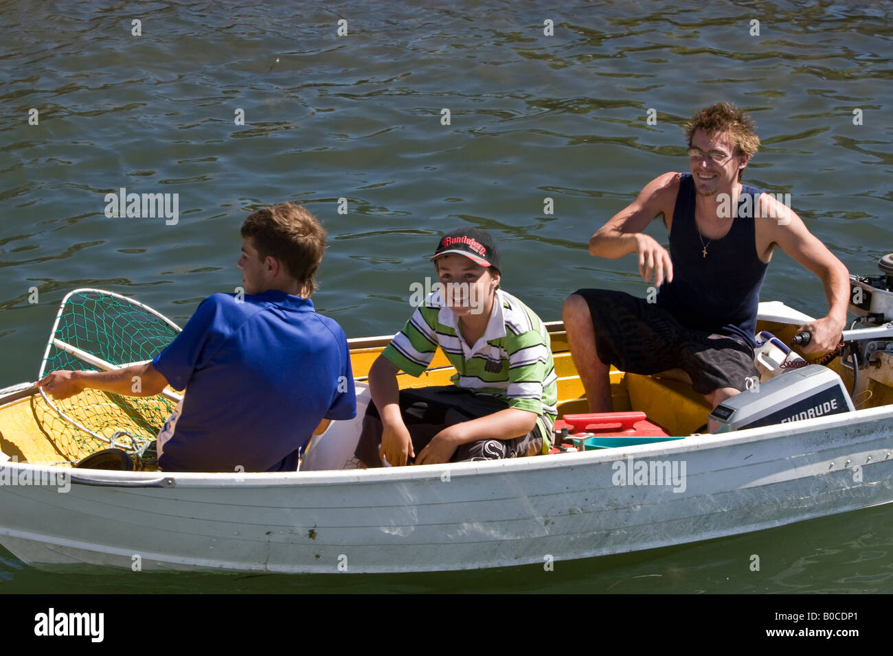 3 people out fishing Stock Photo - Alamy