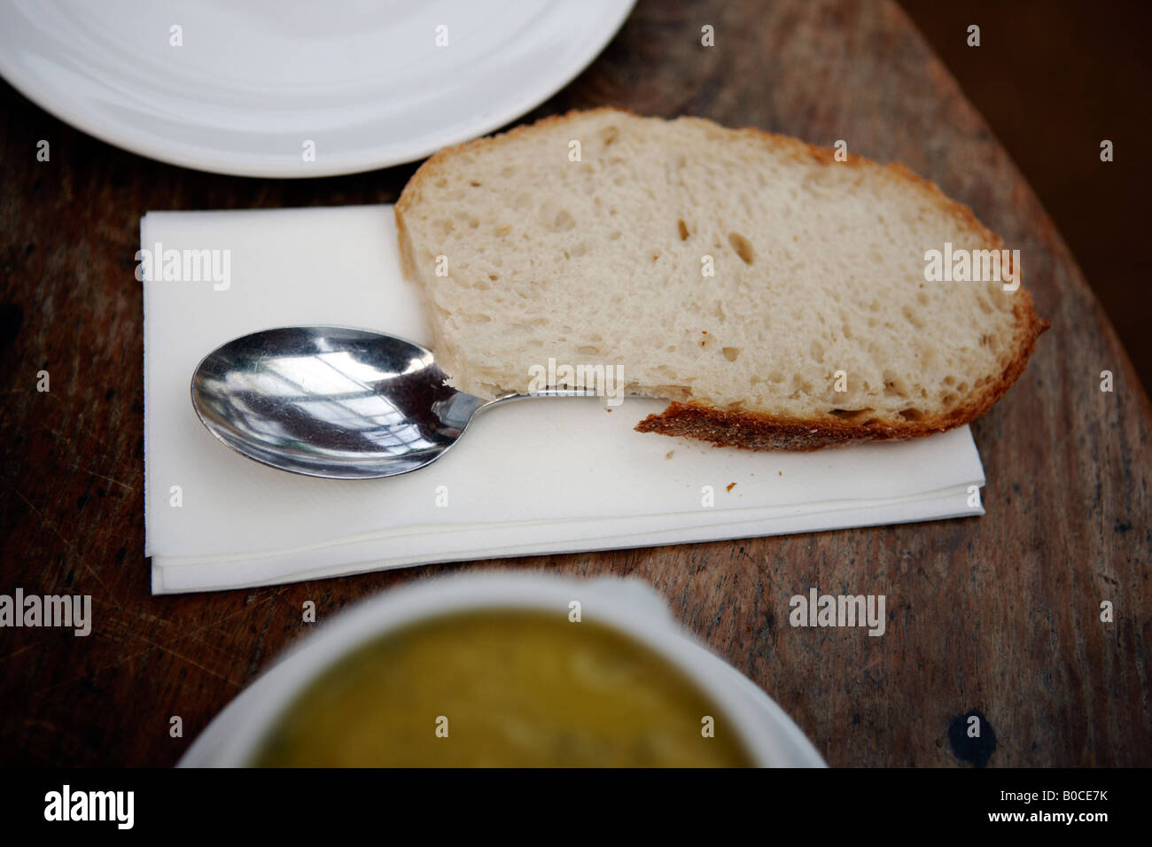 Chunky slice of bread, with a soup spoon. Stock Photo