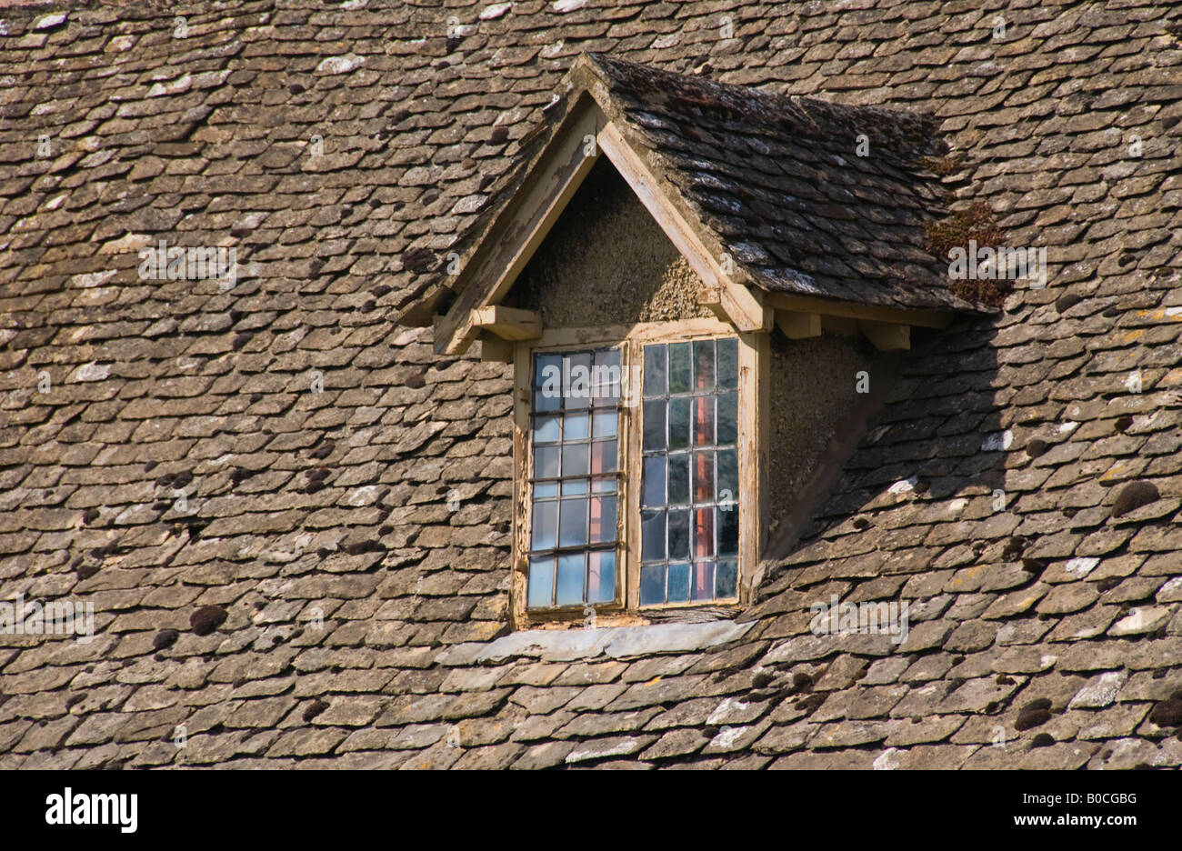 Dormer window on cottage with stone tile roof in village of Broadway Worcestershire Cotswolds England UK Stock Photo