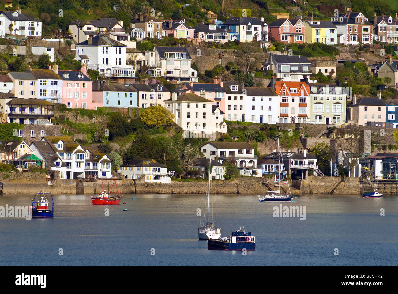 Houses line the hillside above boats in the harbour in Dartmouth, Devon