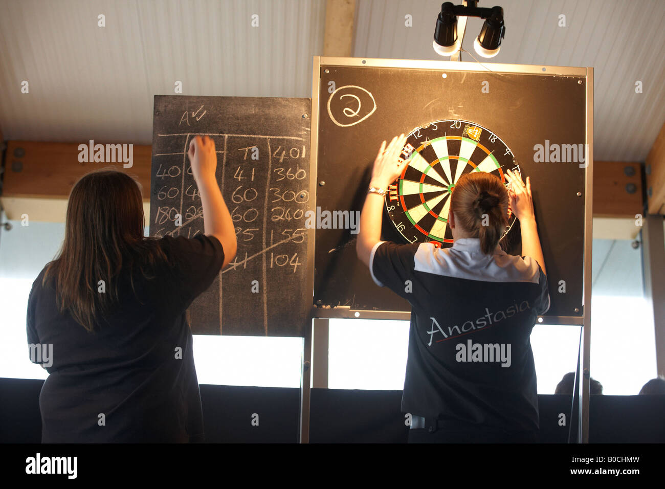 Ladies darts champion Anastasia Dobromyslova retrieves her darts after
