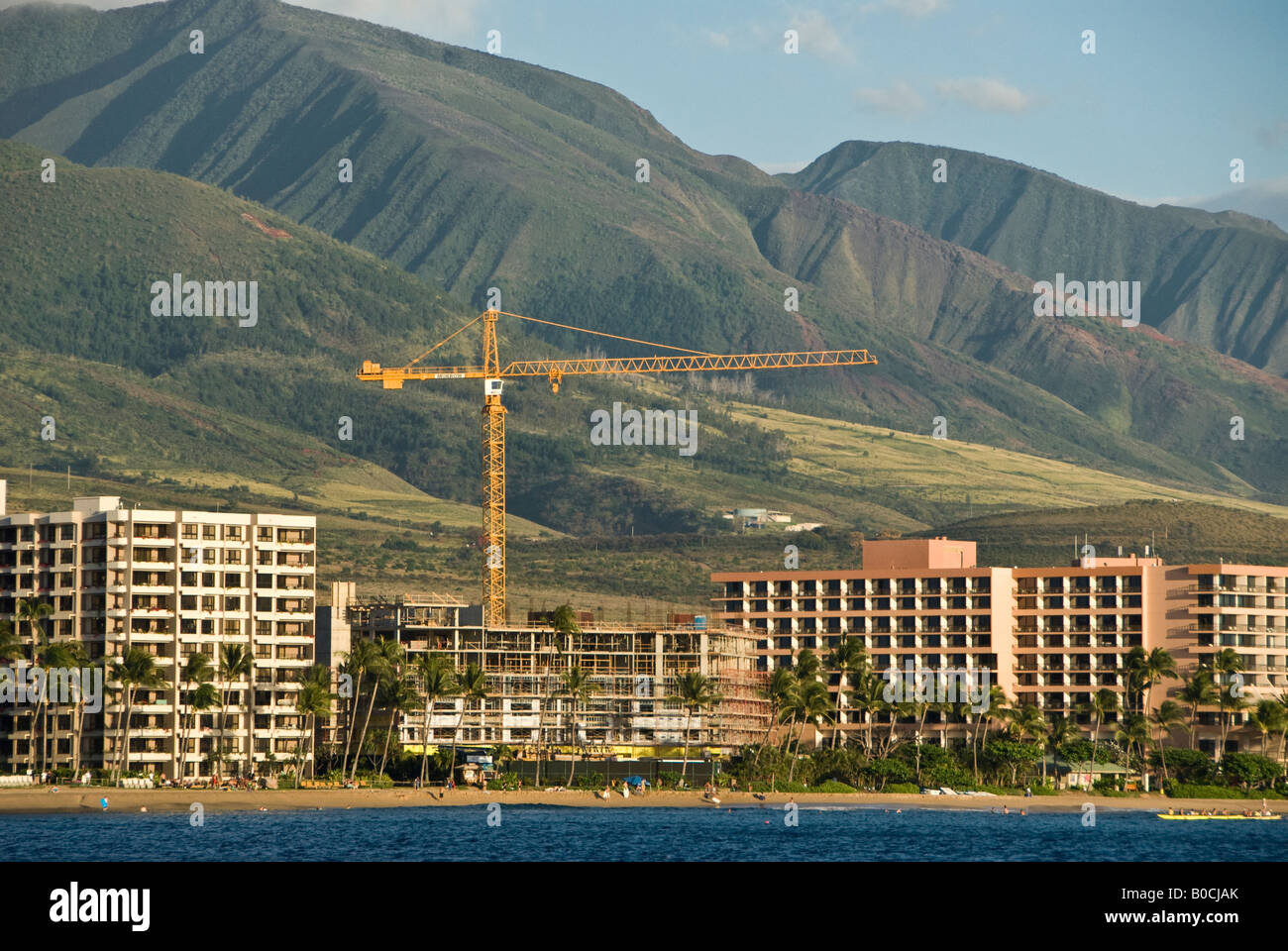 Construction crane at project site near Mauna Kahalawai West Maui mountains Hawaii Stock Photo