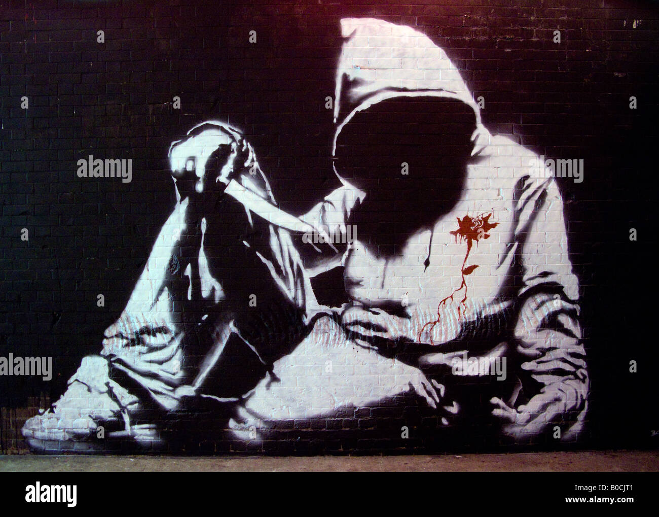 Hoodie with knife, faceless hooded teenager - an image from The Cans Festival, a London street exhibition Banksy helped to open Stock Photo