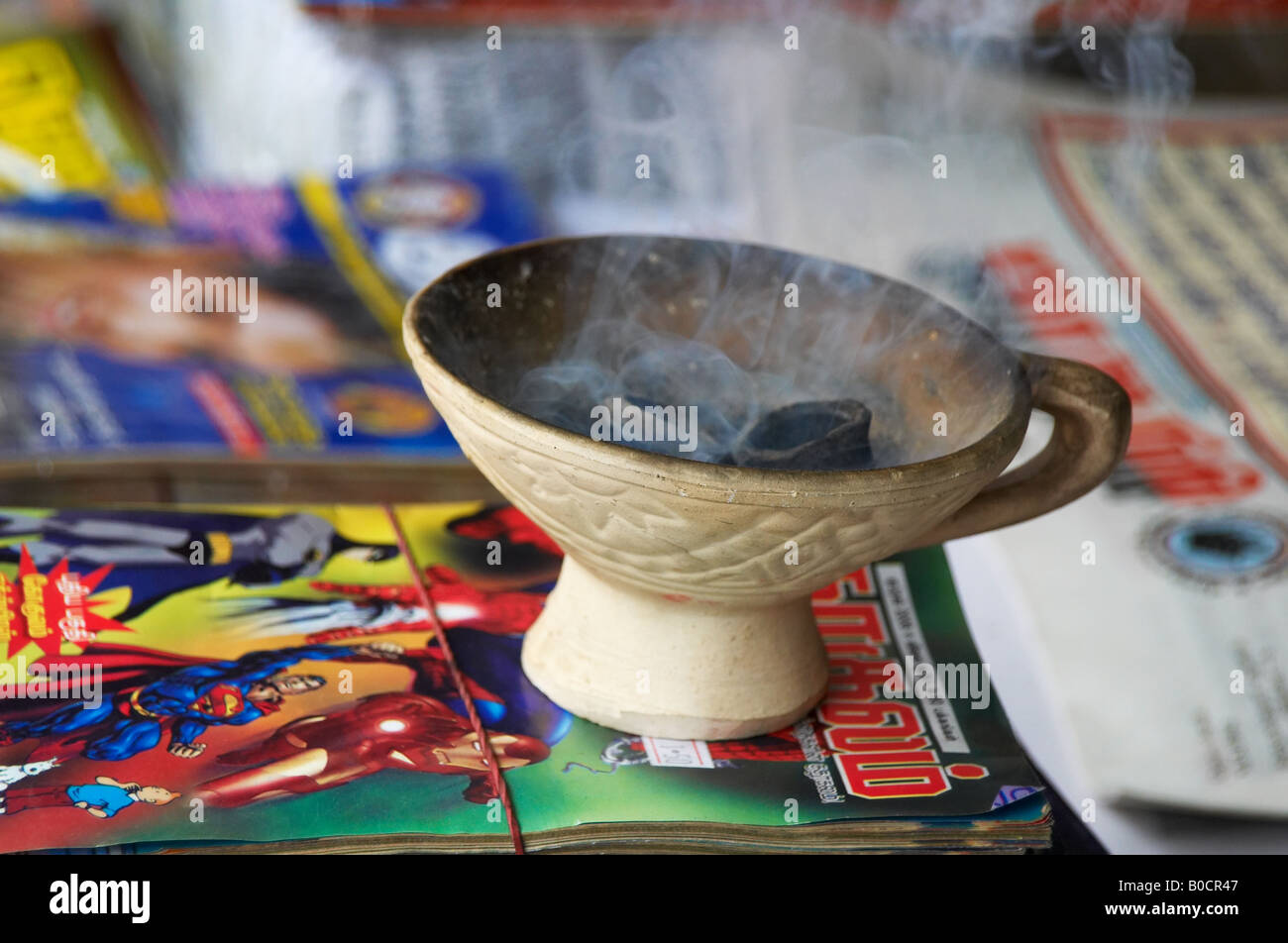 Incense burner at a sidewalk magazine stall in Little India, Singapore Stock Photo