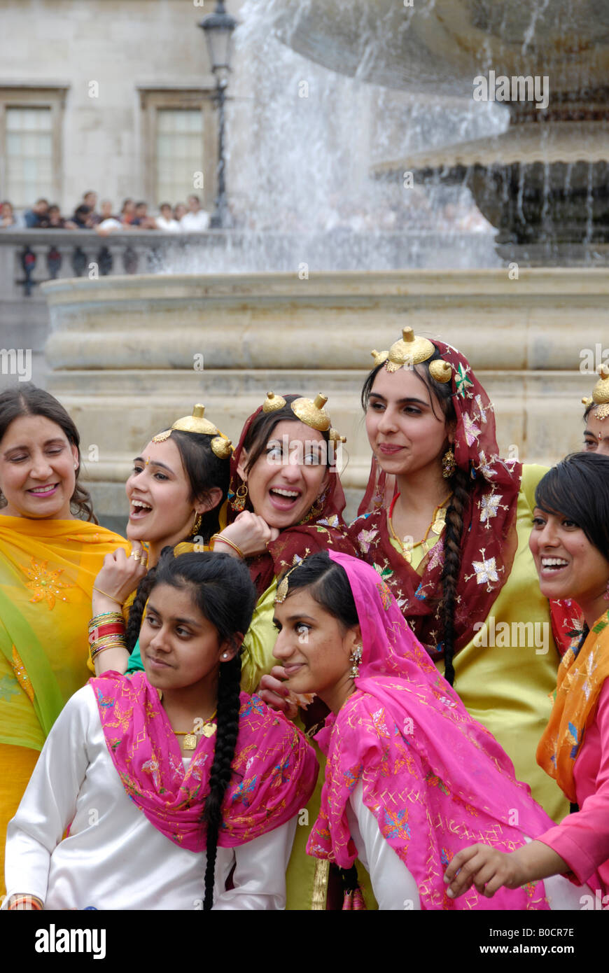 Young Indian females in colourful traditional costumes at 2008 Vaisakhi Sikh New Year Festival in Trafalgar Square London Stock Photo