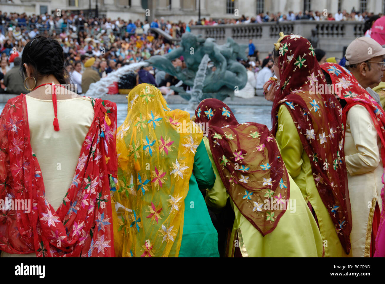 Rear view of Indian women in colourful traditional costumes at 2008 Vaisakhi Sikh New Year Festival in Trafalgar Square, London Stock Photo