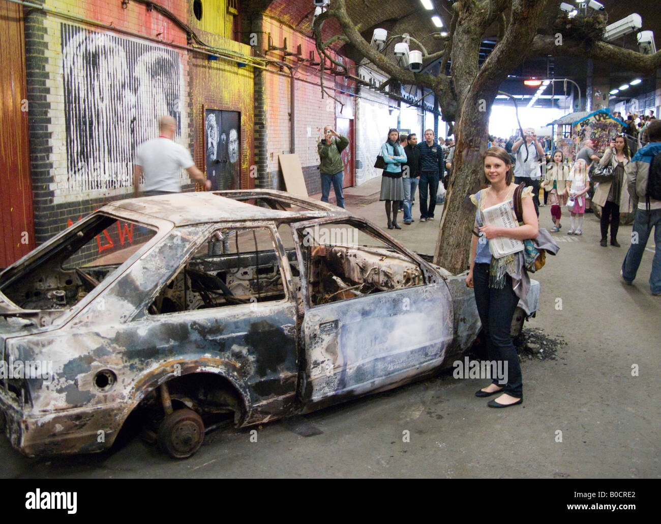 Burnt out stripped car - an image from The Cans Festival, a London street exhibition graffito artist Banksy helped to open Stock Photo