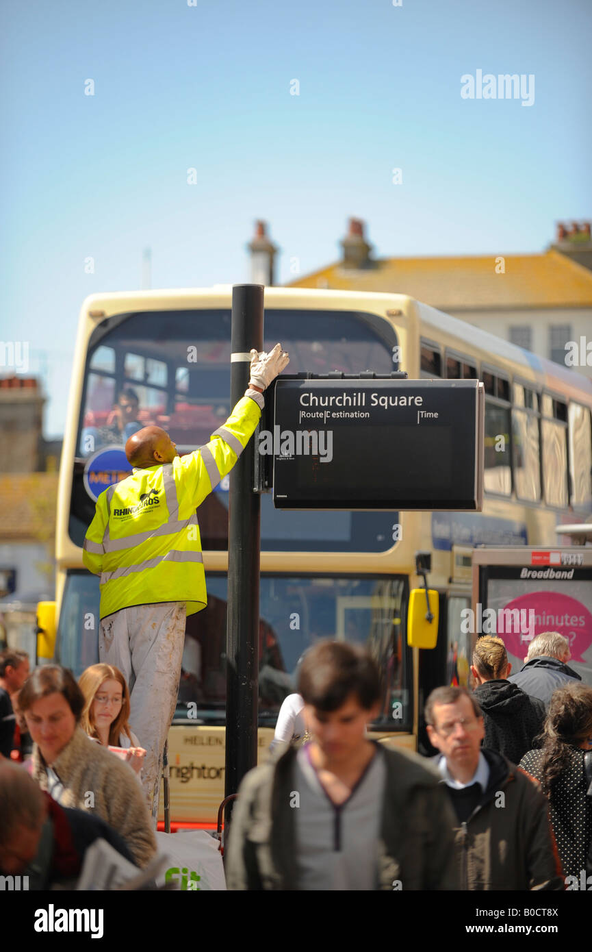 A workman painting a bus stop in Churchill Square, Brighton. Picture by Jim Holden. Stock Photo