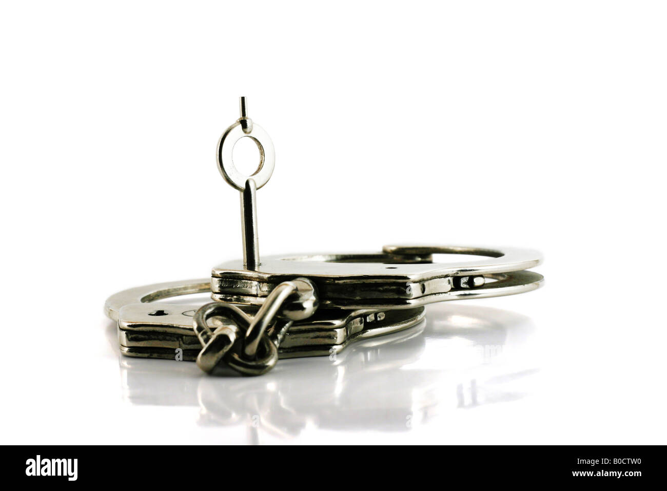 handcuffs with key in focus isolated on white Stock Photo Alamy