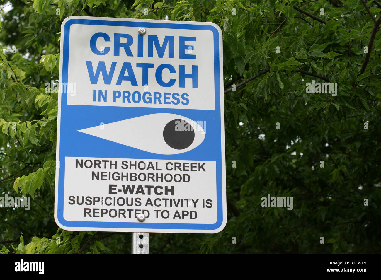 Neighborhood watch sign reads Crime watch in progress Stock Photo