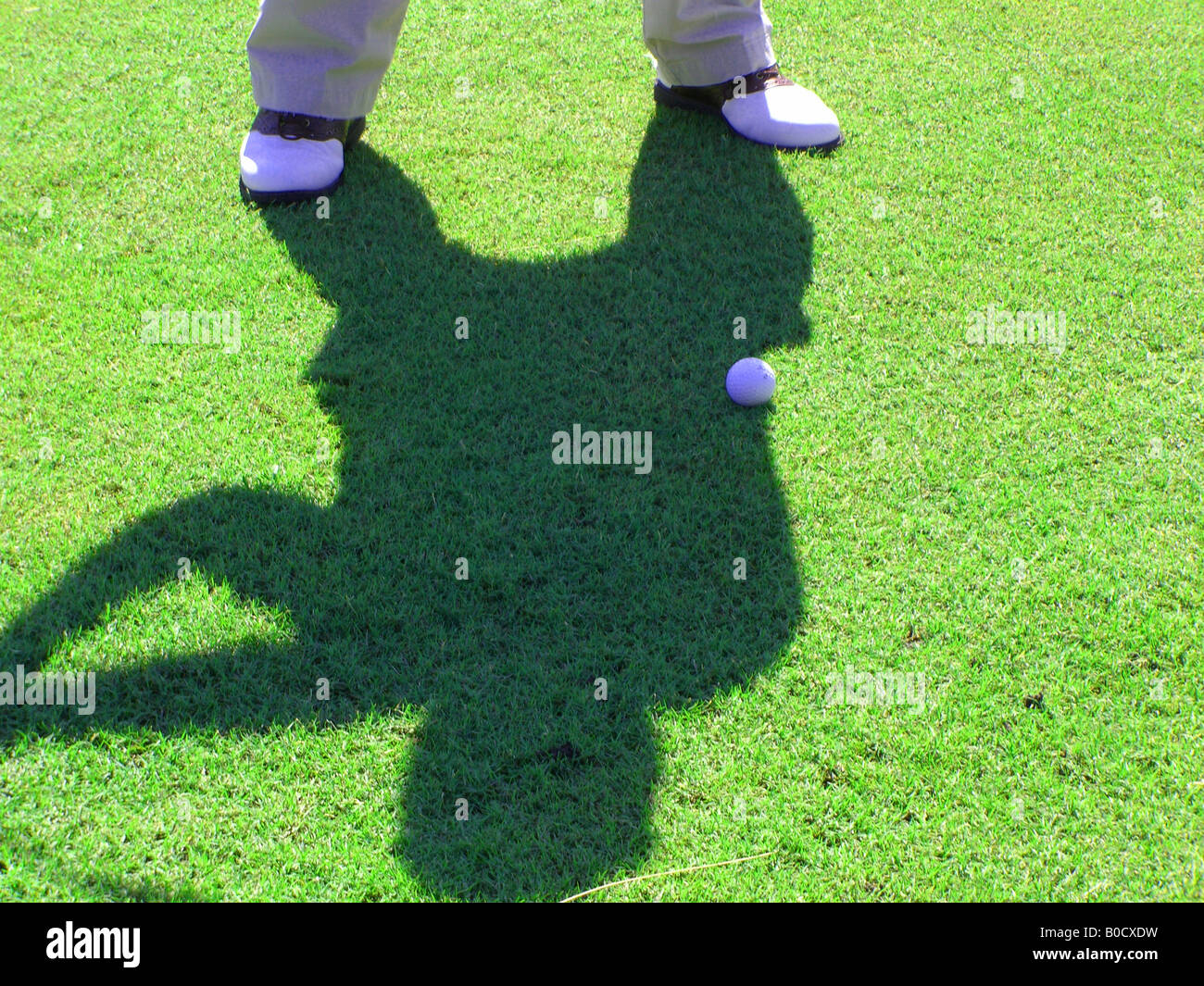 Golf swing shadow Stock Photo