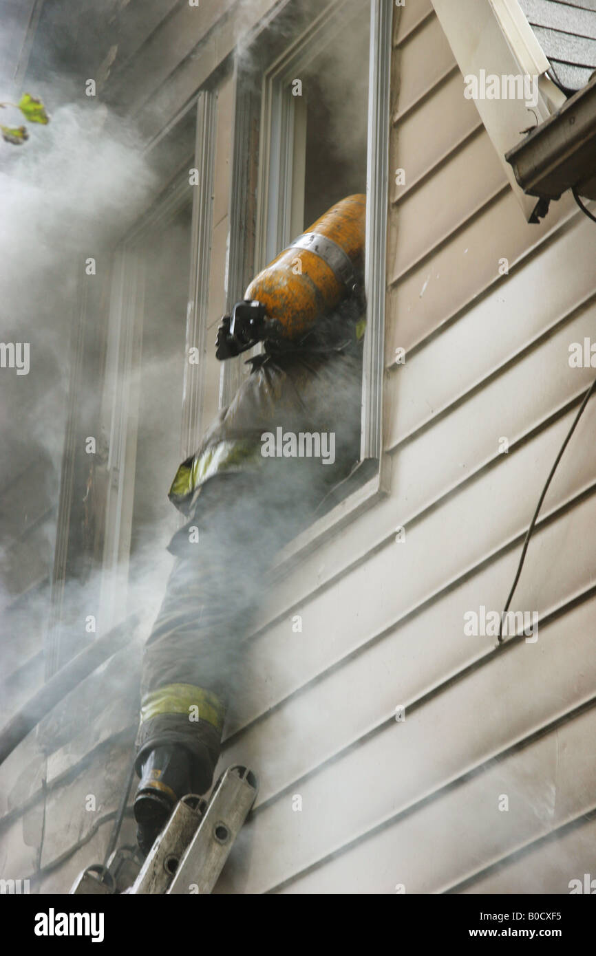 Firefighter entering house Detroit Michigan USA, by David Traiforos/Dembinsky Photo Assoc Stock Photo