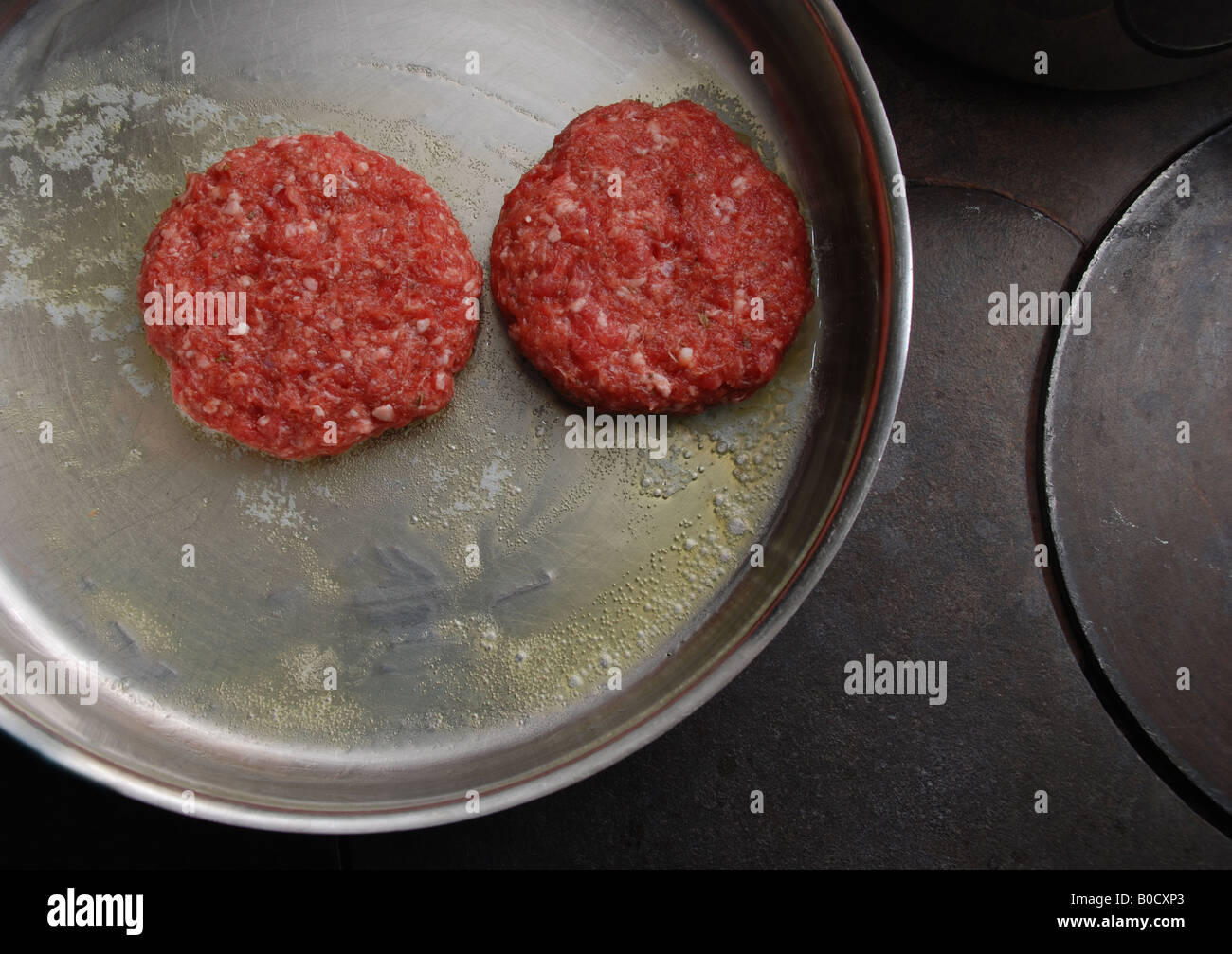 Two hamburgers just in a frying pan Stock Photo Alamy