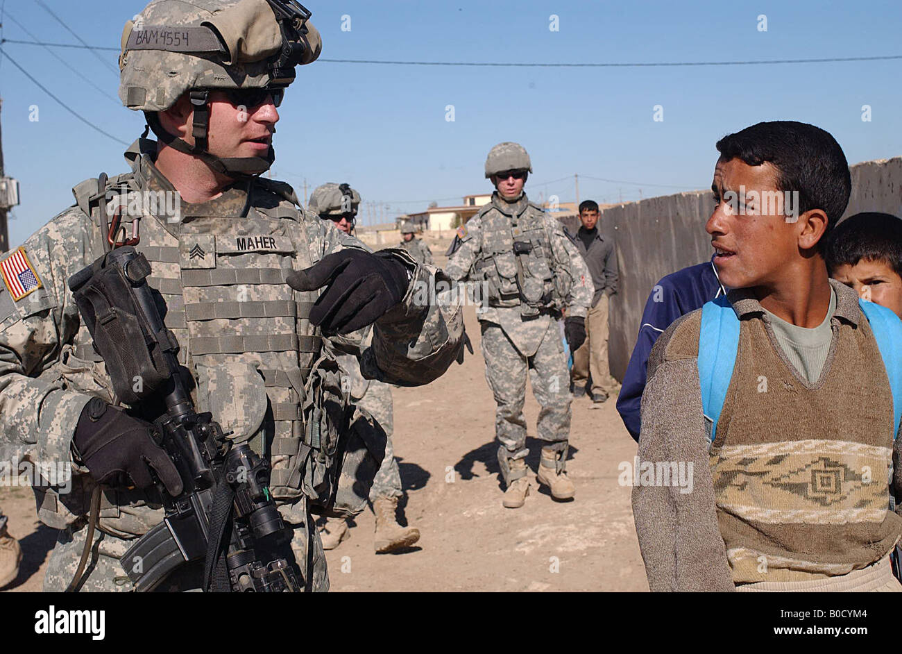 U S Army Sgt Frankie Maher left talks with Iraqi children in Musayd Iraq on April 25 2007 Stock Photo