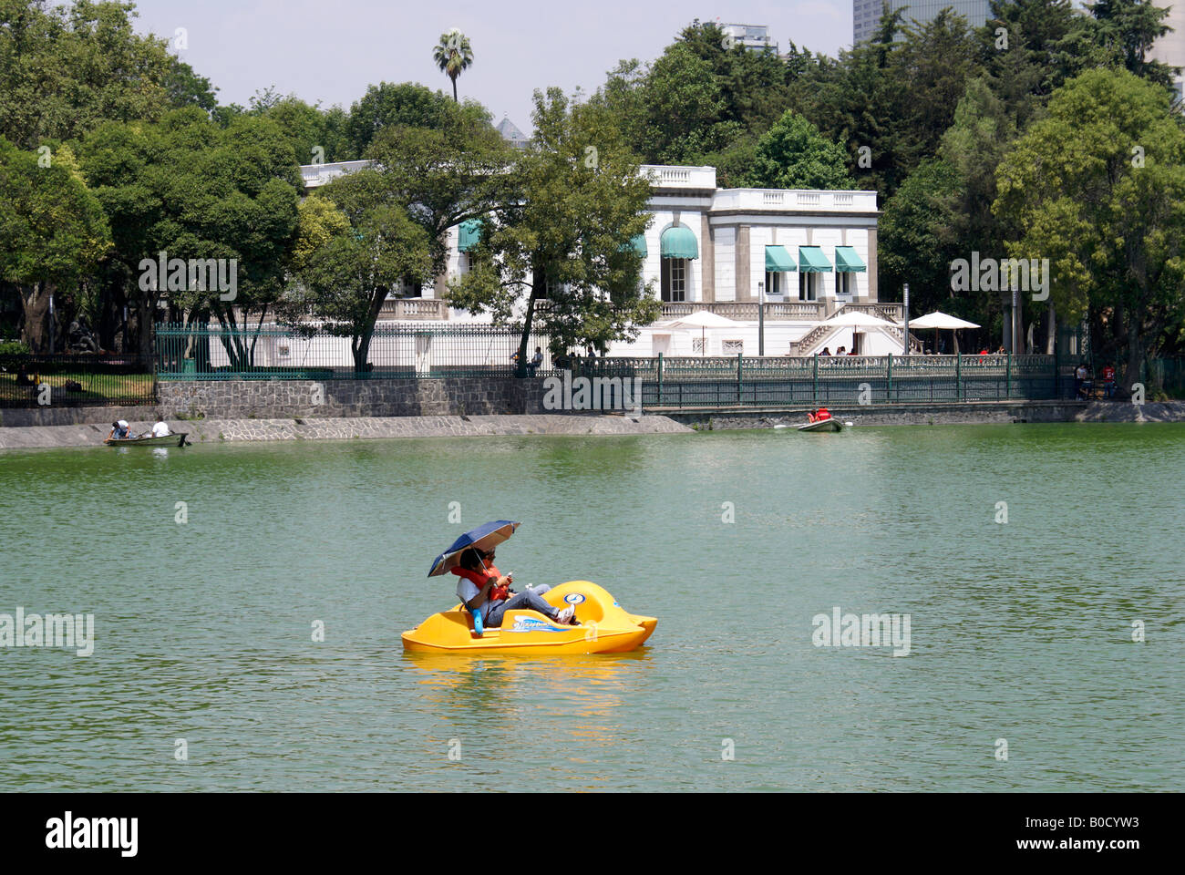 Yellow paddle boat in front of the Casa del Lago on Lago de Chapultepec in Chapultepec Park, Mexico City Stock Photo