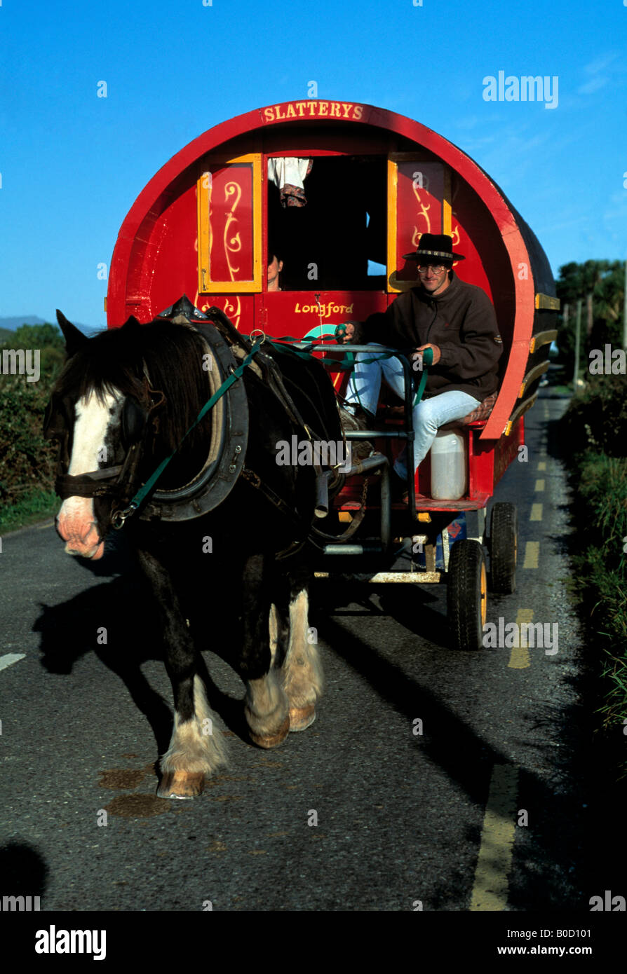 horse drawn gypsy caravan on an irish country road Stock Photo