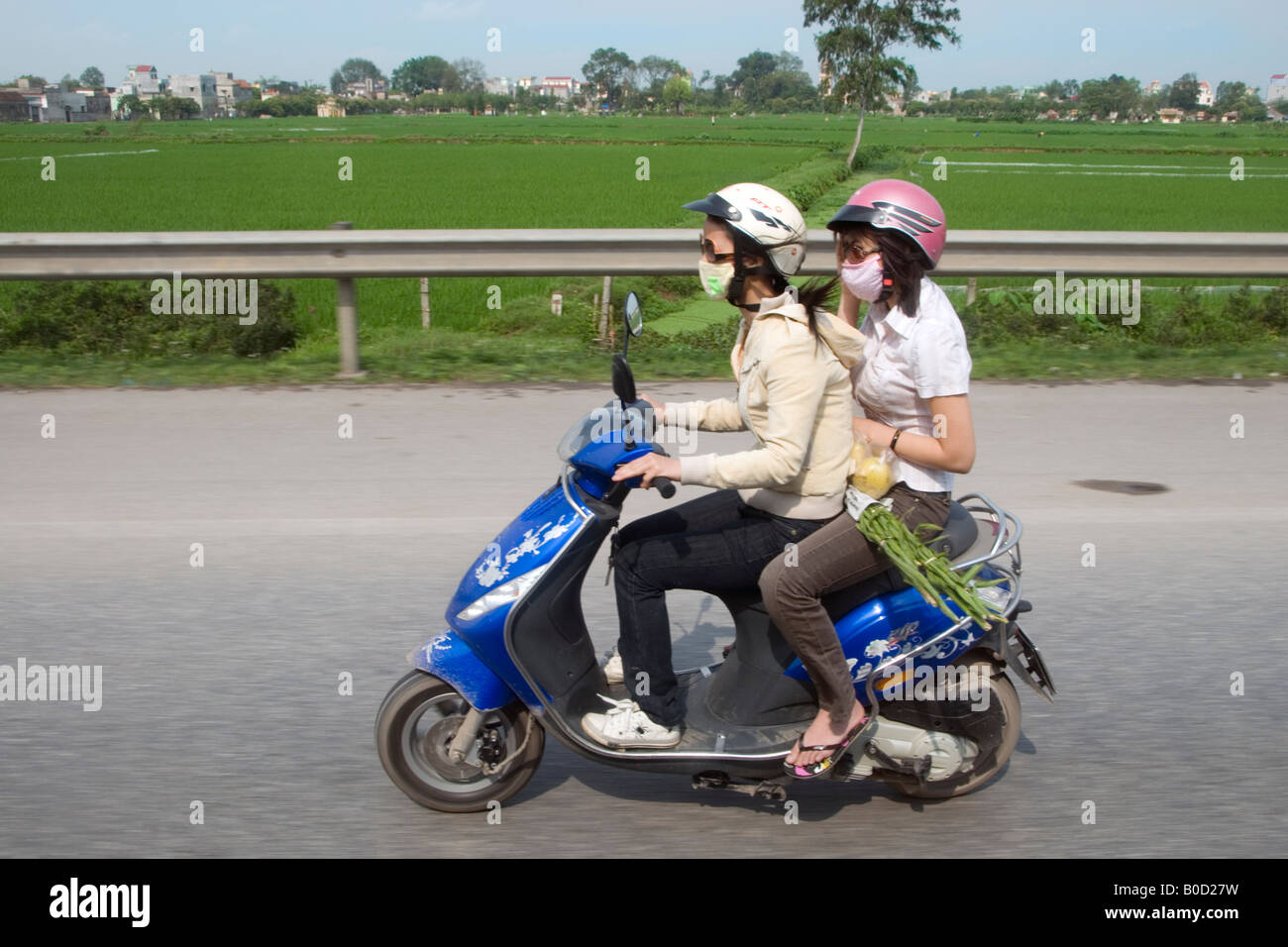 Two young women on a scooter on a highway south of Hanoi, Vietnam Stock  Photo - Alamy