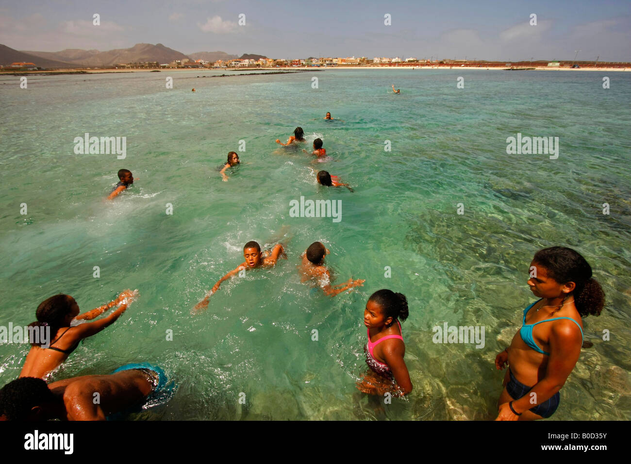 youth swimming in the clear water at the beach Baia das Gatas on Sao Vicente island Cape Verde Africa Stock Photo