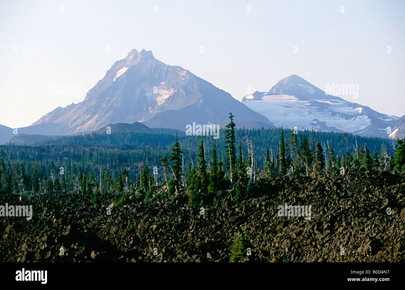 A view of glaciers on North Sisters peak and Middle Sisters peak over an alpine lava flow on the McKenzie Pass Scenic Byway Stock Photo