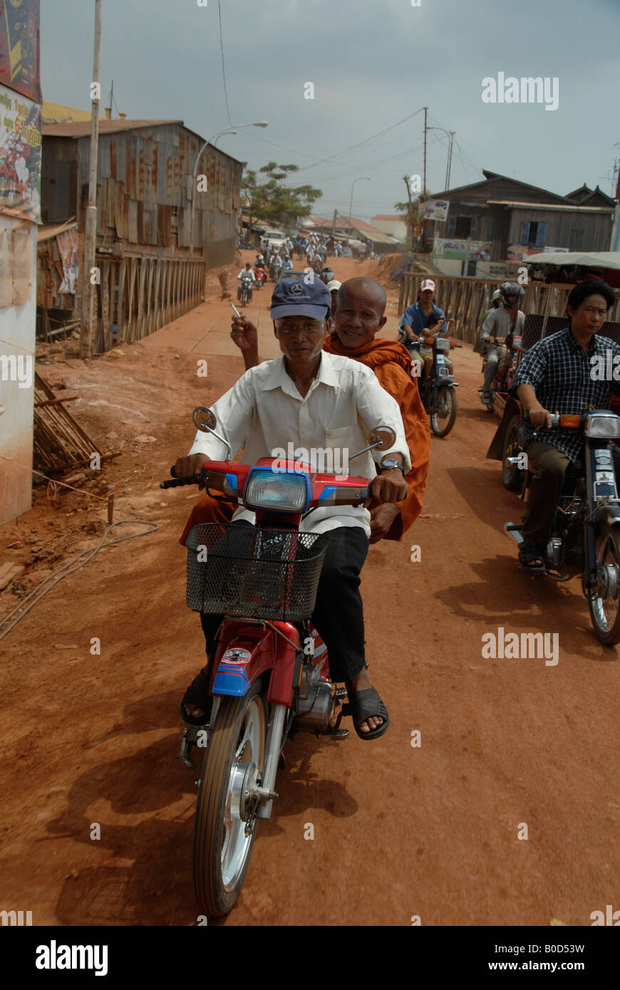 monk smoking on the motorbike, phnom penh, cambodia Stock Photo
