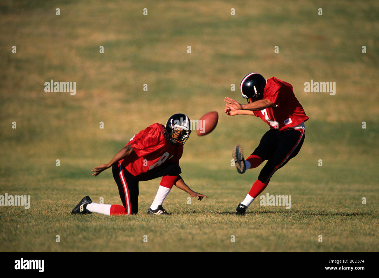 Football place kicker and holder in action Stock Photo Alamy