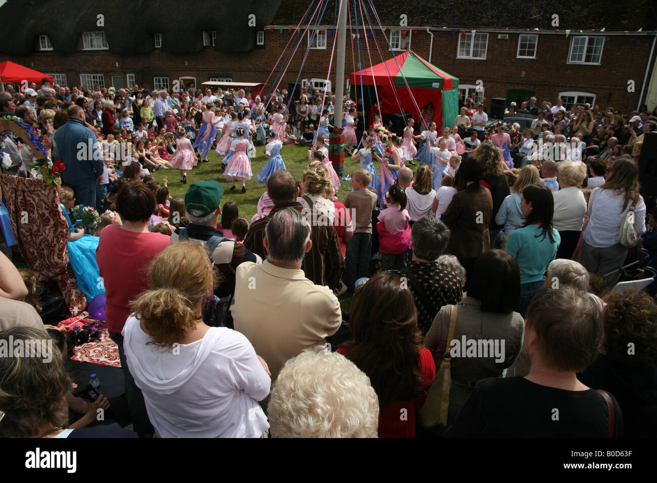 Children dancing around the Maypole at The Downton Cuckoo Fair Stock