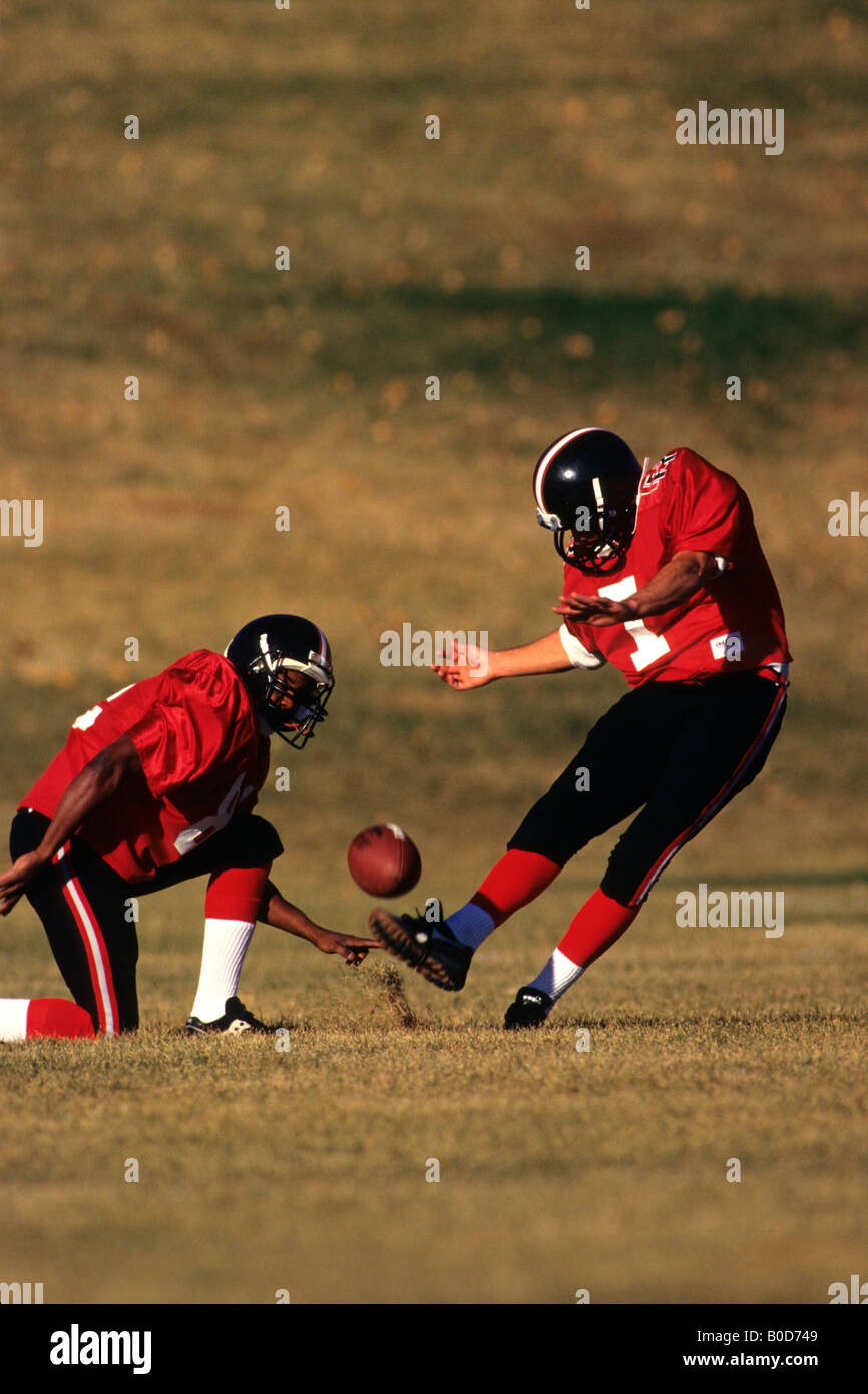Football place kicker and holder in action Stock Photo
