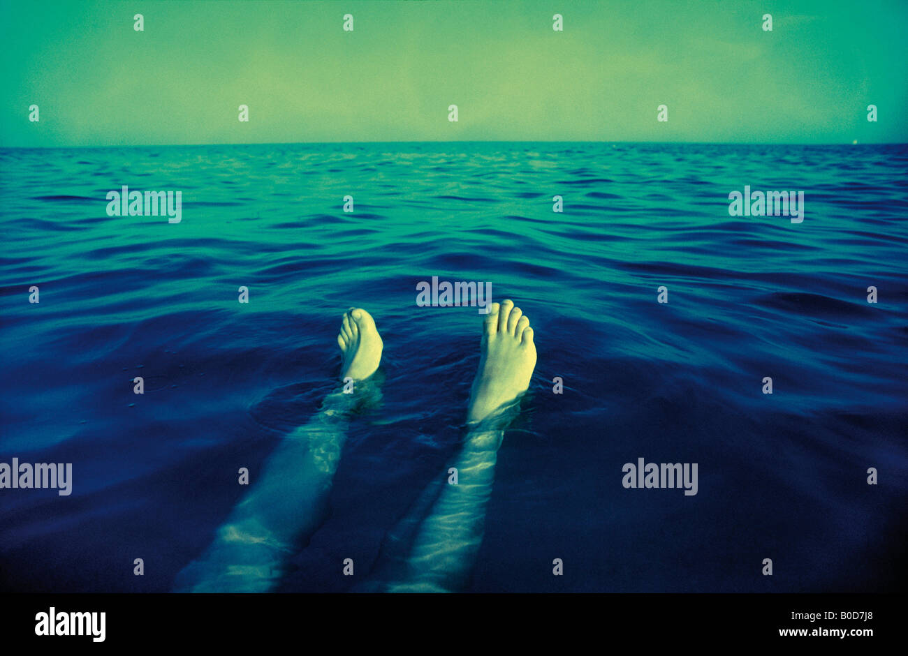 LEGS SWIMMING RELAXED ON SEA Stock Photo