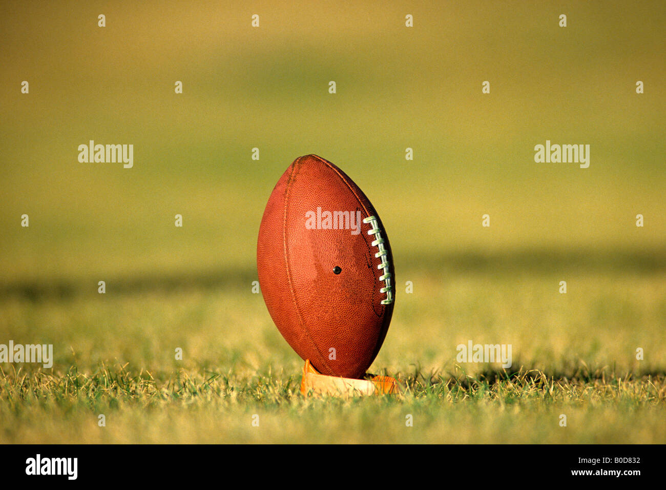 American football on kicking tee Stock Photo Alamy