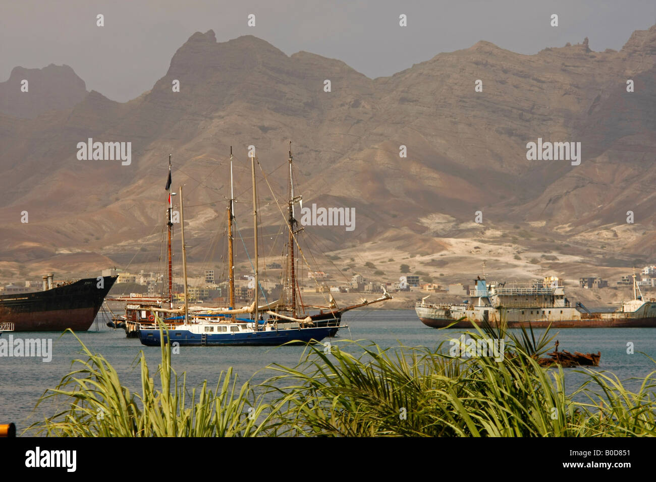 sailing boat in the marina and the dry mountains of Sao Vicente island Cape Verde Africa Stock Photo