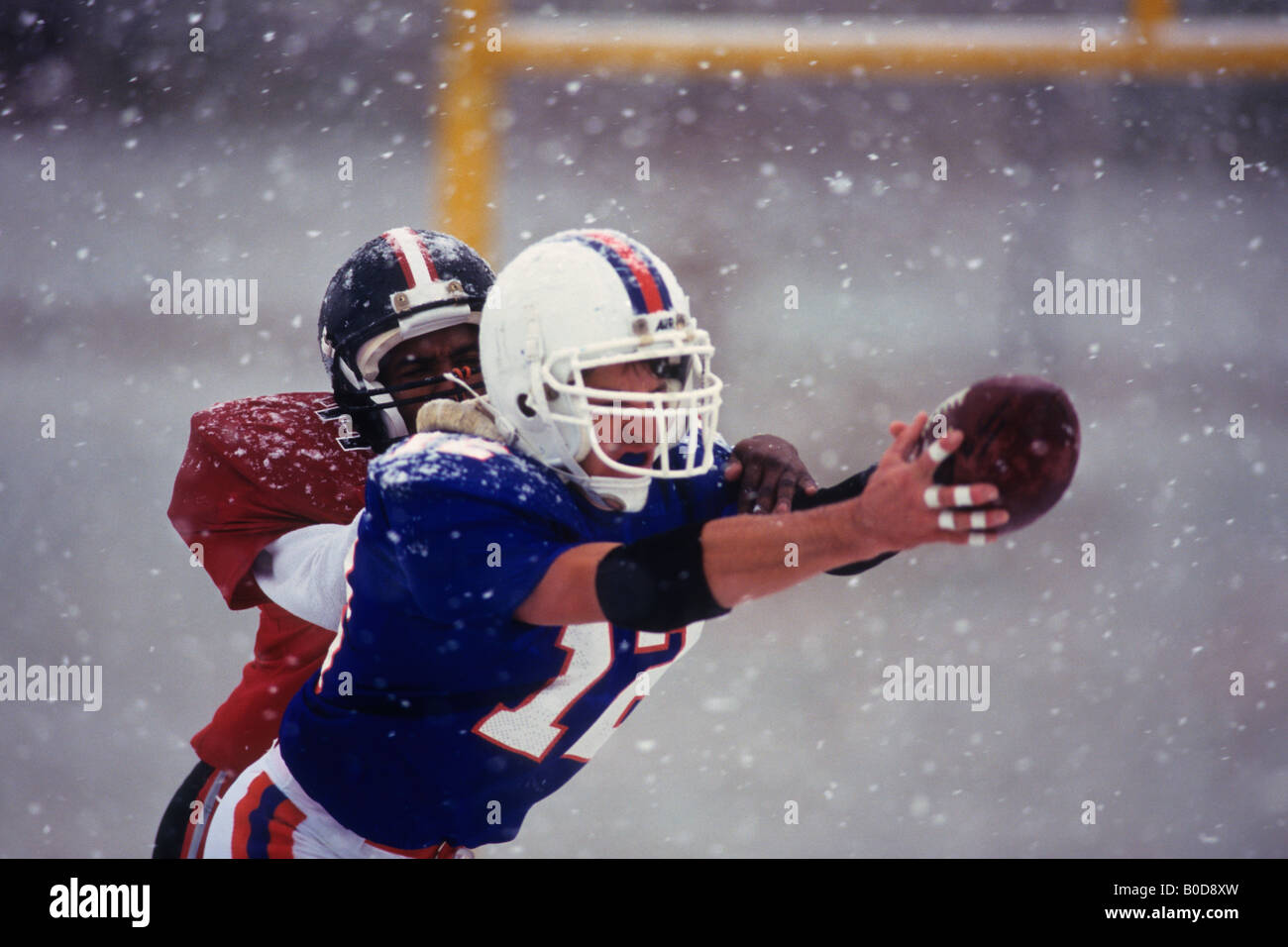 American football player reaching for the ball Stock Photo - Alamy