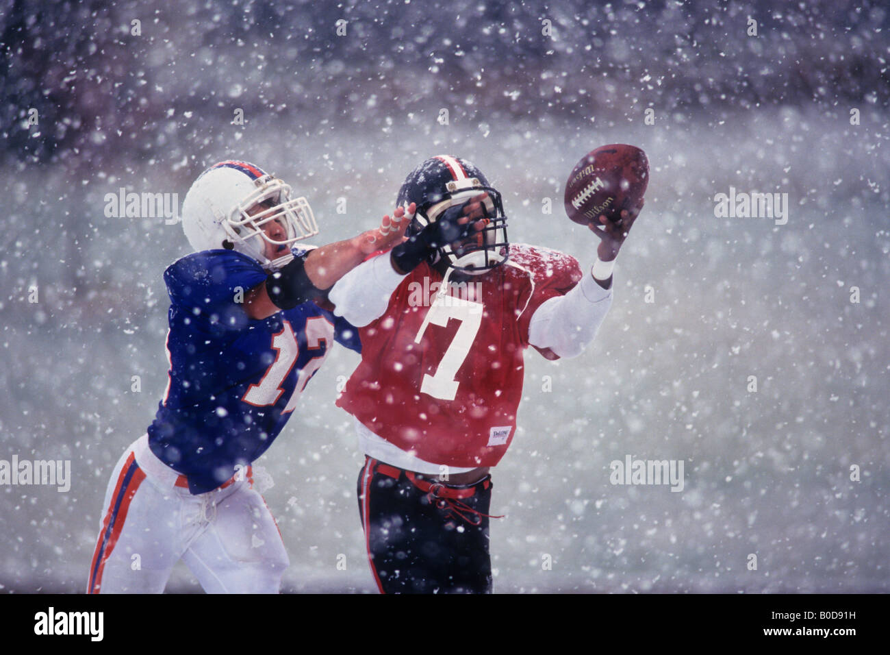 American football player reaching for the ball Stock Photo - Alamy