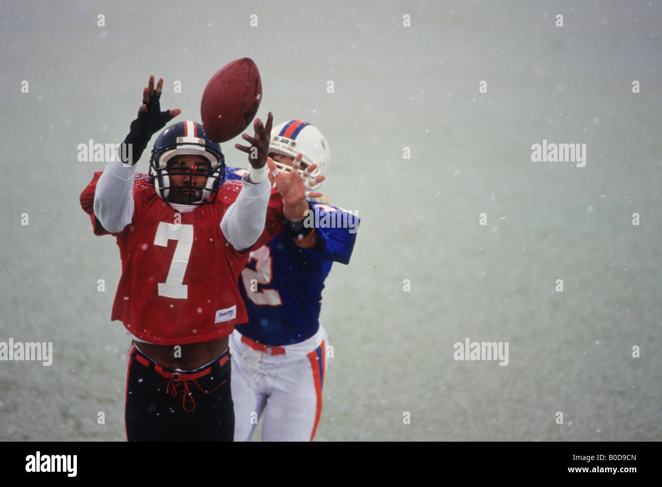 American football player reaching for the ball Stock Photo - Alamy