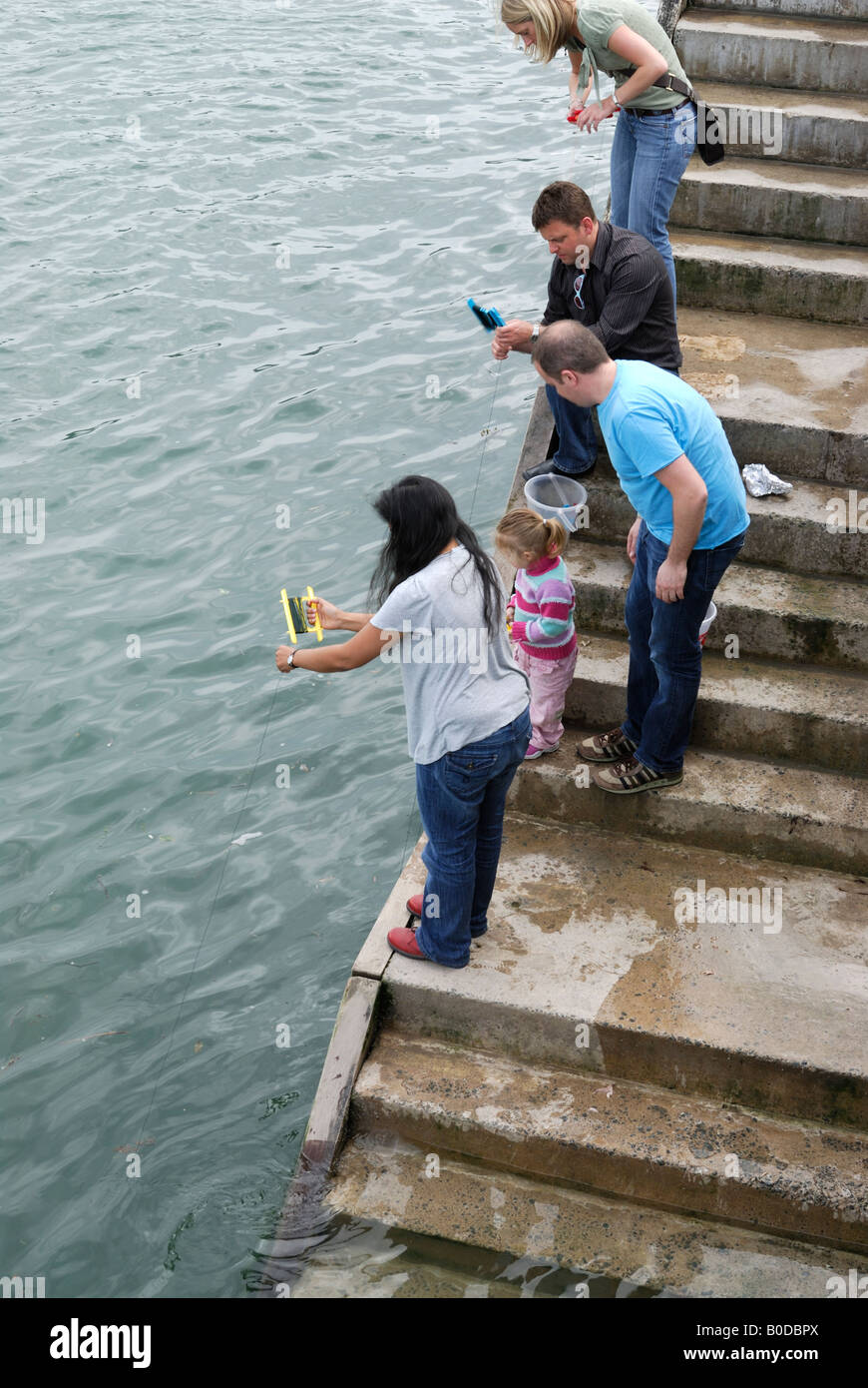 People fishing for crabs in Dartmouth, Devon, UK Stock Photo
