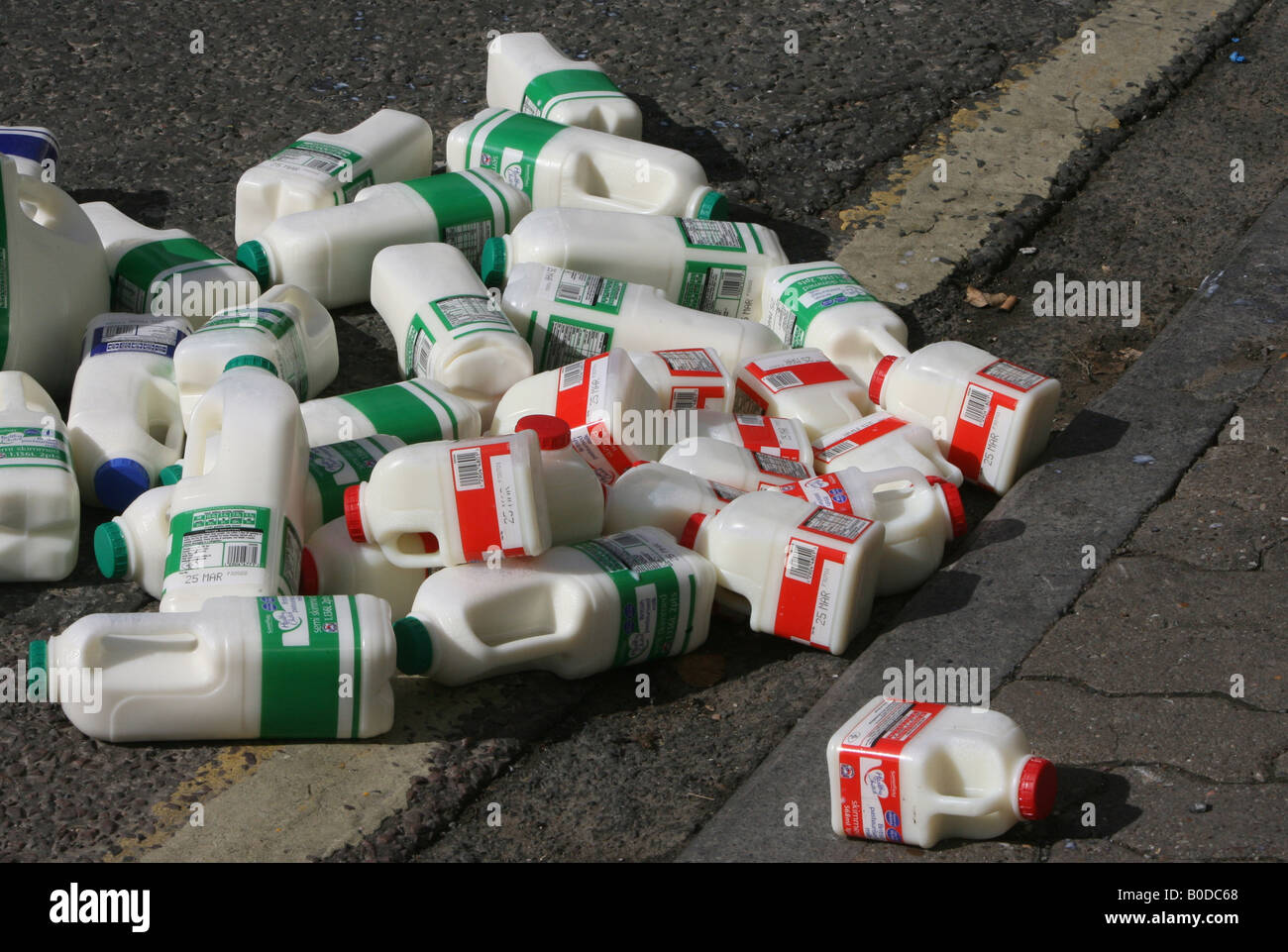 Pints of spilt milk on a pavement await to be cleared by the milkman in
