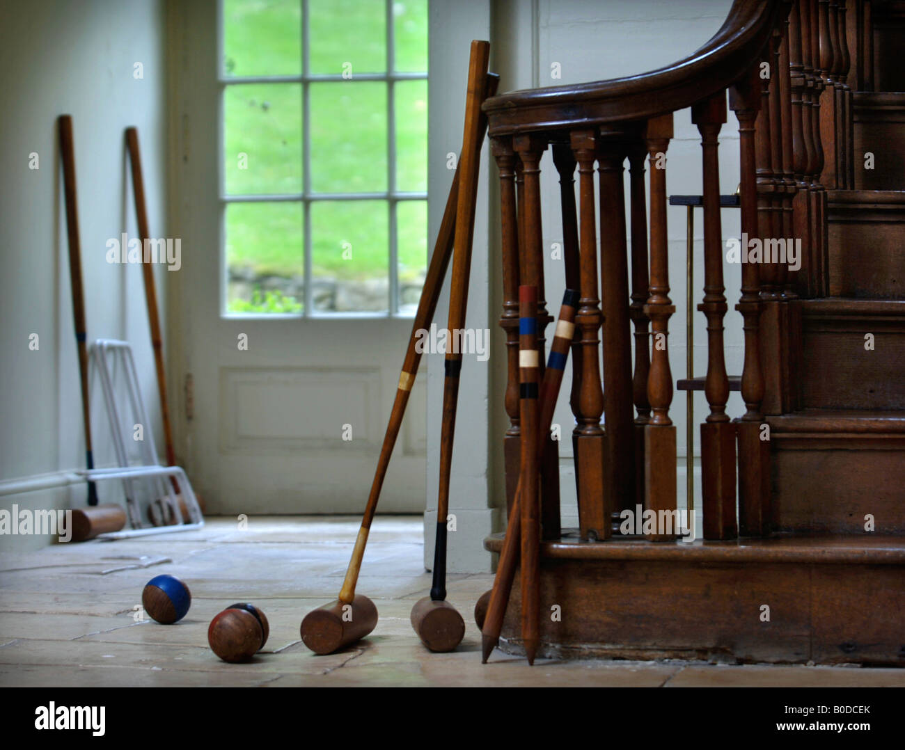 CROQUET MALLETS BALLS AND HOOPS BY THE BACK DOOR OF A COUNTRY HOUSE UK Stock Photo