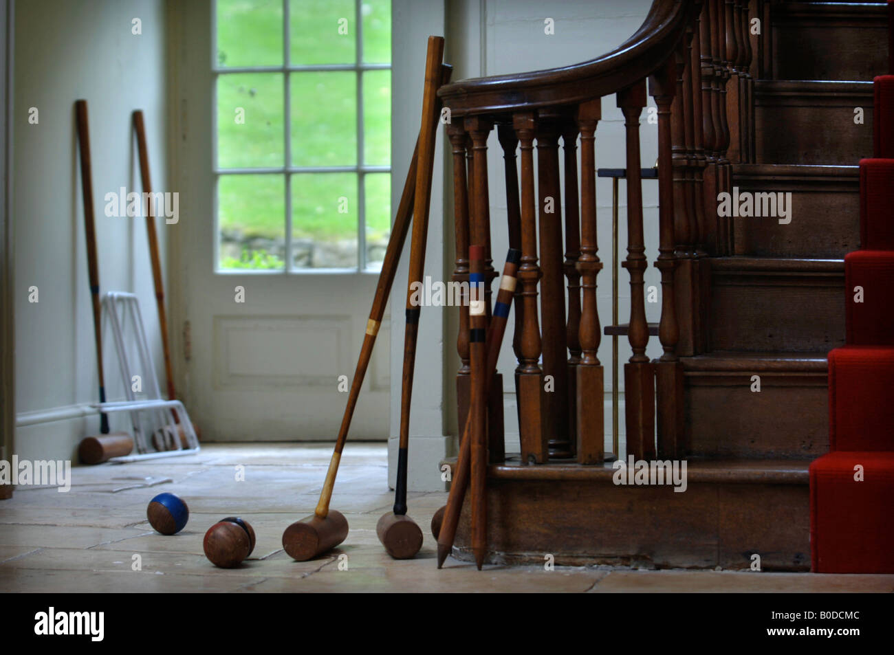 CROQUET MALLETS BALLS AND HOOPS BY THE BACK DOOR OF A COUNTRY HOUSE UK Stock Photo