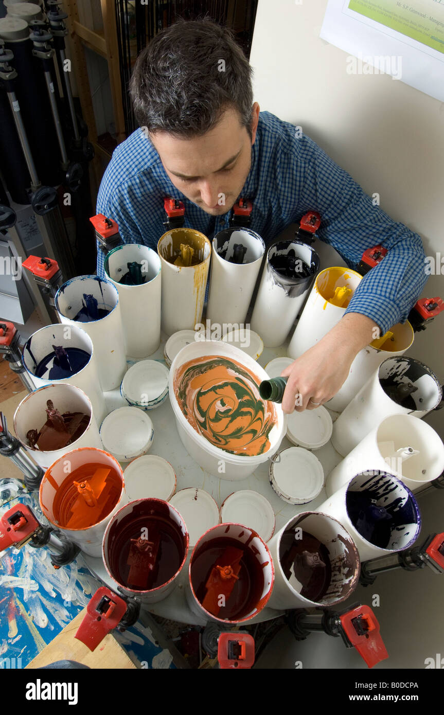 A man mixing paints and blending colours in a making bespoke