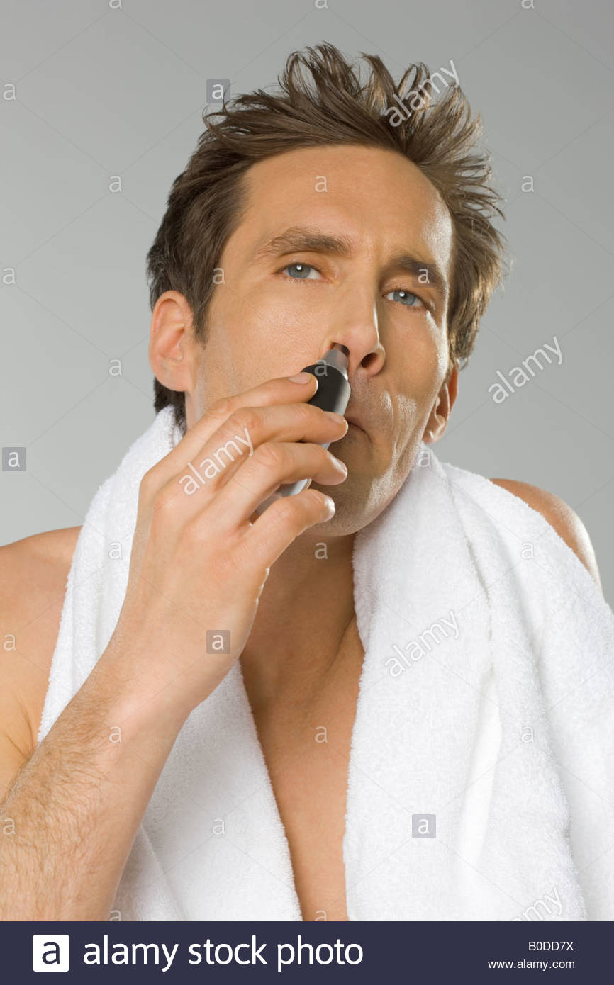 Mid Adult Man Using Nose Hair Trimmer Stock Photo 17506158 Alamy