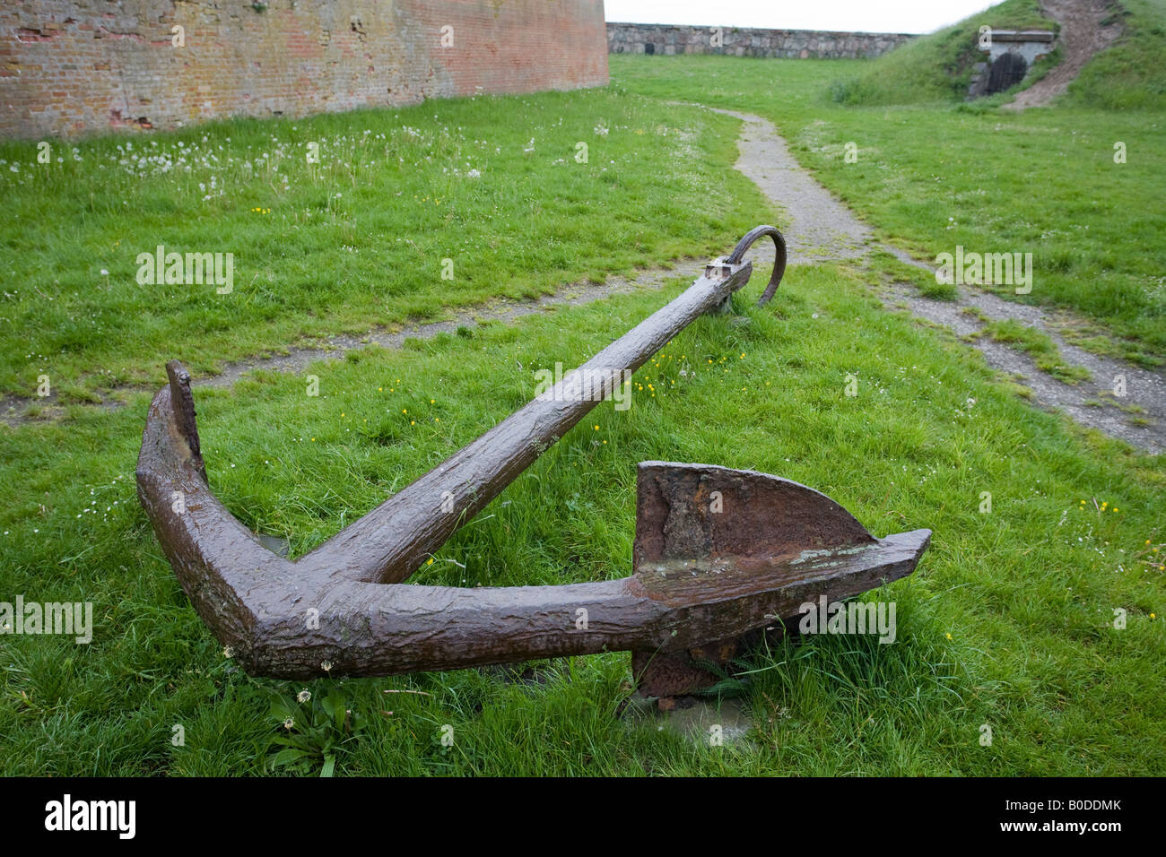 Anchor Pathway A large old iron anchor marks the point where a path divides in the outer moat of the castle Stock Photo
